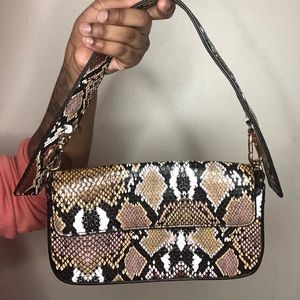 printed purse with two straps, long and short.